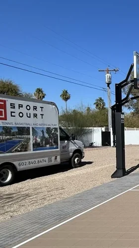 Sport Court company truck parked alongside backyard sports court